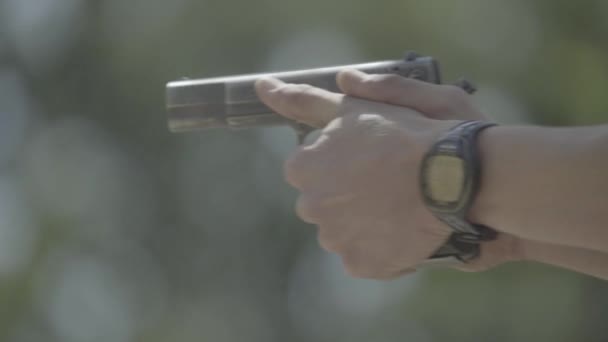 Close-up shot of a pistol. Shooting — Stock Video
