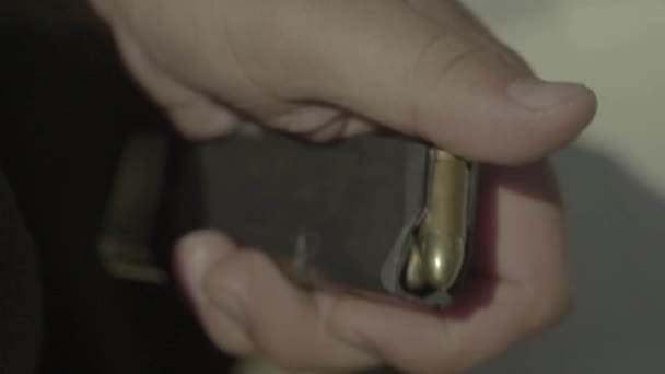 Les cartouches sont chargées dans le pistolet. Gros plan. — Video