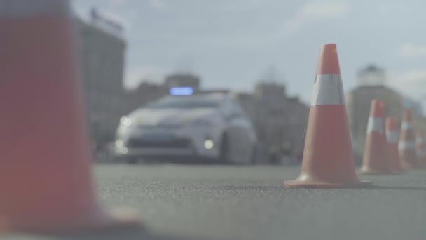 Police cone on the road. Place of accident. Transport. Road traffic. Sign. Kyiv. — ストック動画