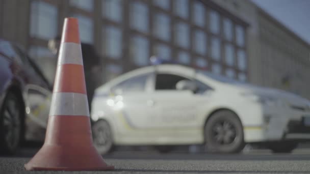 Police cone on the road. Place of accident. Transport. Road traffic. Sign. Kyiv. — Stock Video