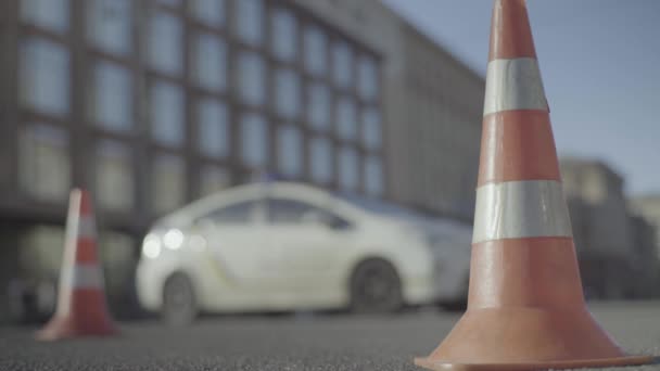 Police cone on the road. Place of accident. Transport. Road traffic. Sign. Kyiv. — ストック動画