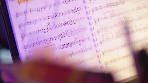 Sheet music on stage during the performance of the orchestra. Close-up. — Stock Video