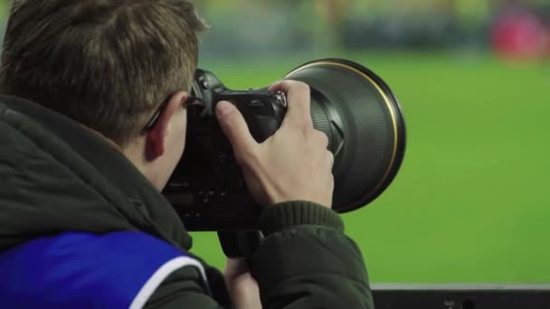 Egy fotós, fotósok egy kamerával a stadionban egy focimeccs alatt. — Stock videók