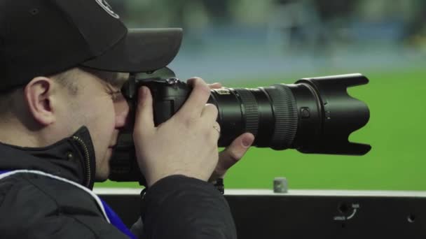 A photographer, photographers with a camera in a stadium during a football match. — ストック動画