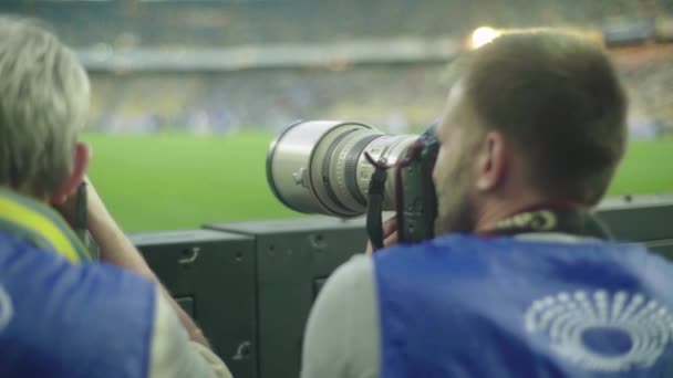 A photographer, photographers with a camera in a stadium during a football match. — 비디오