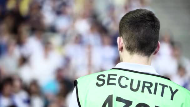 Férfi biztonsági őr egy stadionban egy focimeccsen.. — Stock videók