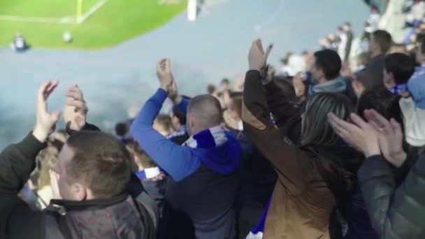 Fans at the stadium during the match. Slow motion. Olimpiyskiy. Kyiv. Ukraine. — ストック動画