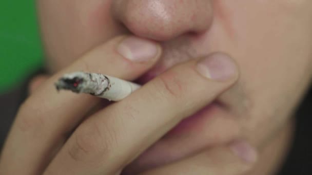 Cigarette in the mouth of a smoker. Close-up. Chroma Key. Green background. — Stock Video