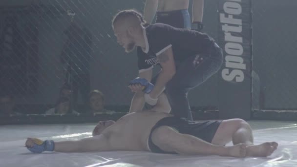A male fighter in the MMA octagon. Slow motion. Kyiv. Ukraine — ストック動画