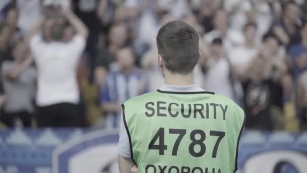 Male security guard in a stadium during a football soccer match. — Stock Video