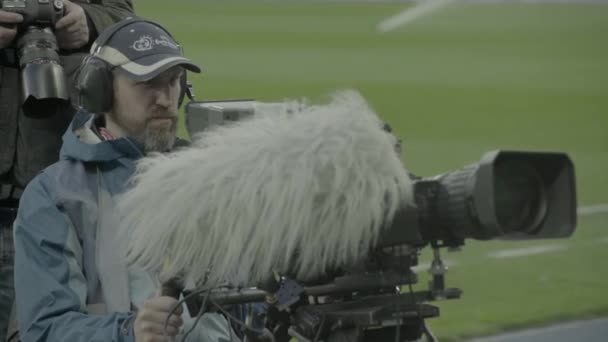 Camarógrafo con una cámara en el estadio durante un partido de fútbol. Televisión — Vídeo de stock