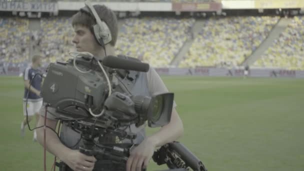 Cameraman with a camera in the stadium during a football match