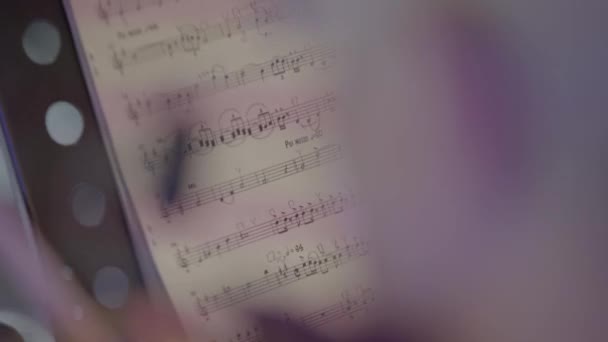 Sheet music on stage during the performance of the orchestra. Close-up. — Stock Video