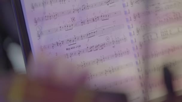 Sheet music on stage during the performance of the orchestra. Close-up. — Stock Video