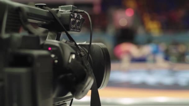 Cameraman with a camera in wrestling competitions. Close-up. — Stock Video