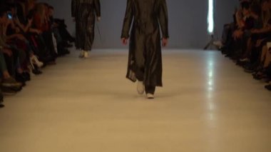 Moda gösterisi. Erkek manken podyumda yürüyor..