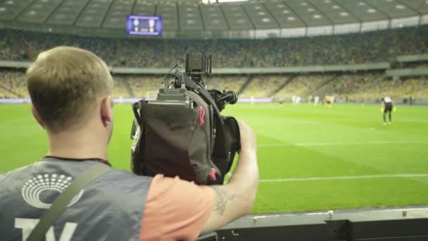 サッカーの試合中にスタジアムでカメラを持つカメラマン。テレビ — ストック動画