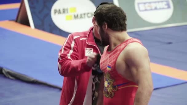 Coach and athlete during break wrestling competitions. Slow motion. Kyiv. Ukraine — Stock Video