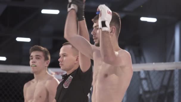 The referee raises the winners hand in the MMA octagon. Slow motion. Kyiv. Ukraine — Stock Video