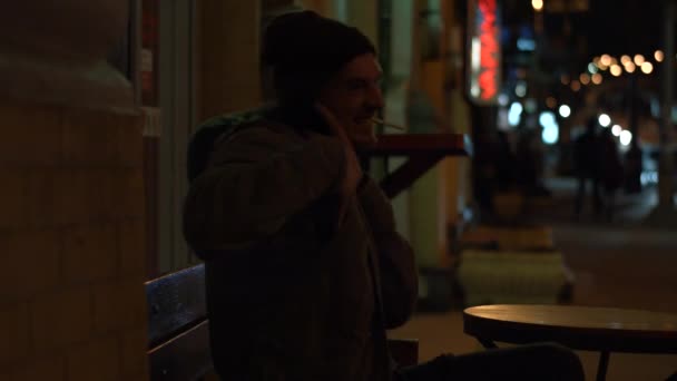 The guy smokes a cigarette at night. Kyiv. Ukraine. — Stock Video