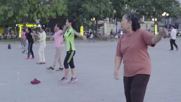 Люди занимаются гимнастикой на площади Пномпеня, Камбоджа, Азия — стоковое видео