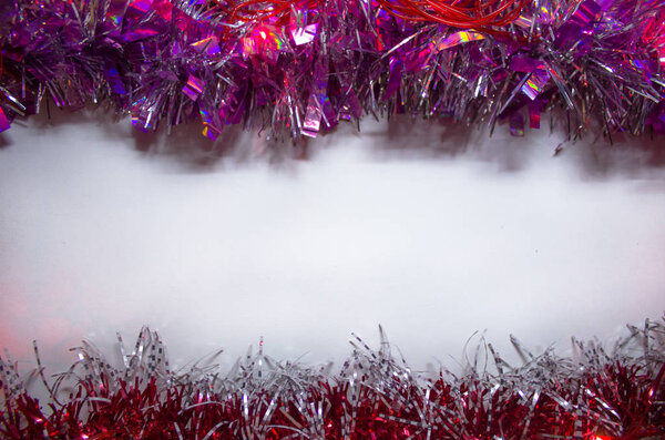 white background with pink tinsel. White background with place for text.