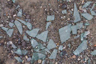 broken glass on the ground. Garbage. Danger