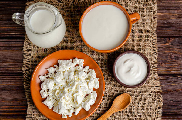 Homemade fermented milk products - kefir, cottage cheese on a wooden background. Healthy eating concept. Ferment for yeast bacterial fermentation, intestinal health concept. View from above.