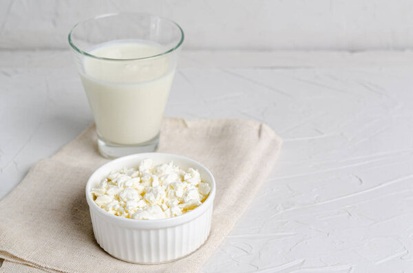Homemade fermented beverage in a glass of kefir and cottage cheese on a white background, copy space. Sour milk drink, sourdough for yeast bacterial fermentation, intestinal health concept.