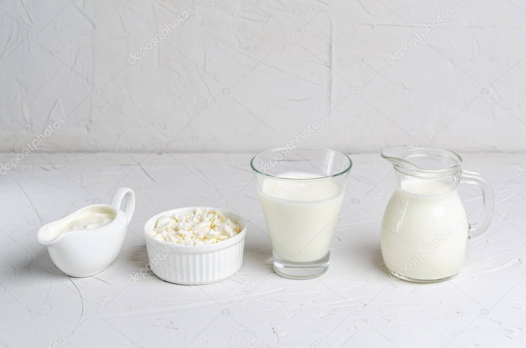Homemade fermented beverage in a glass of kefir, cottage cheese, sour cream on a white background. Sour milk drink, sourdough for yeast bacterial fermentation, intestinal health concept.