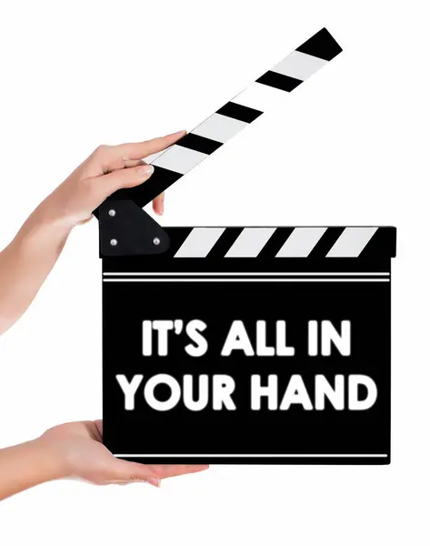 Hands holding a clapper board with IT'S ALL IN YOUR HAND text — Stock Photo, Image