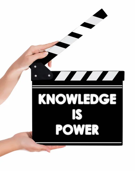Hands holding a clapper board with KNOWLEDGE IS POWER text — Stock Photo, Image