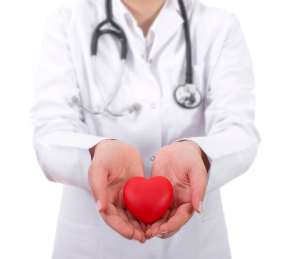 Positive female doctor standing with stethoscope and red heart s