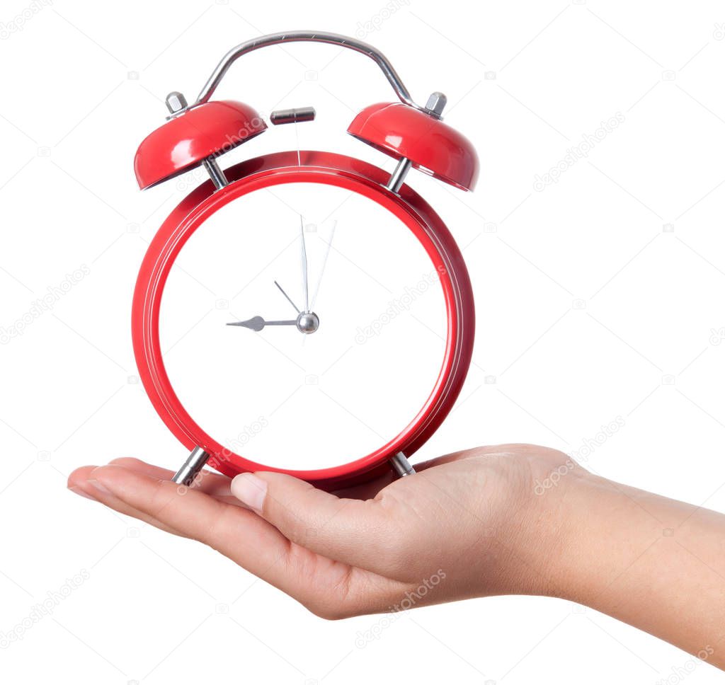 Closeup shot of a woman holding red heartshape alarm clock. Clos