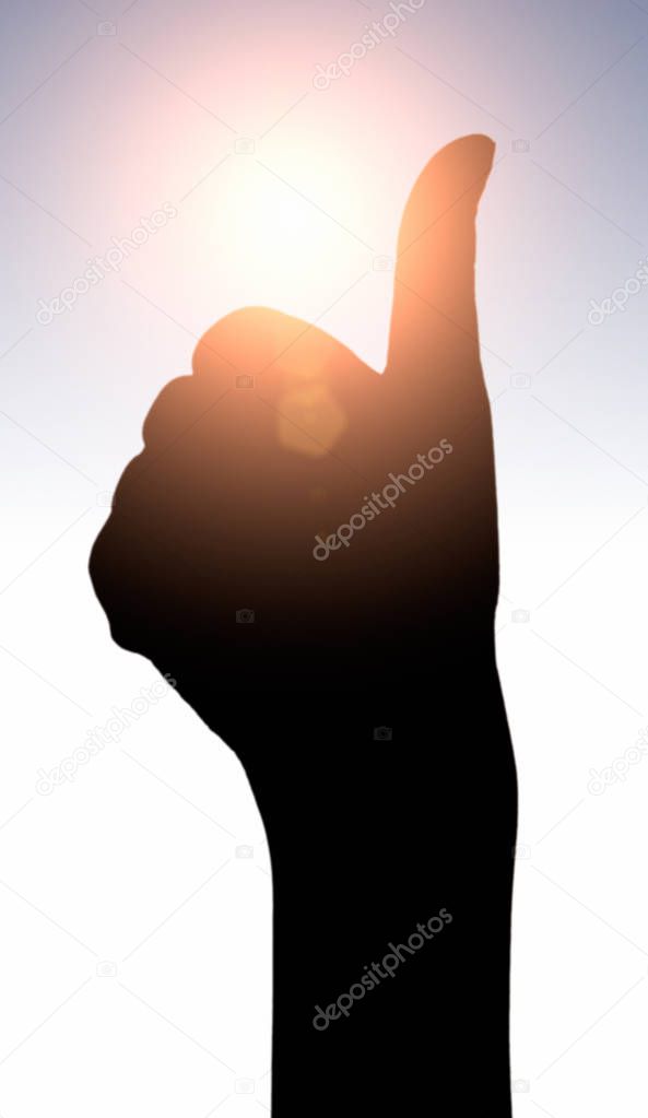 Raised hands catching sun on sunset sky. Concept of spirituality