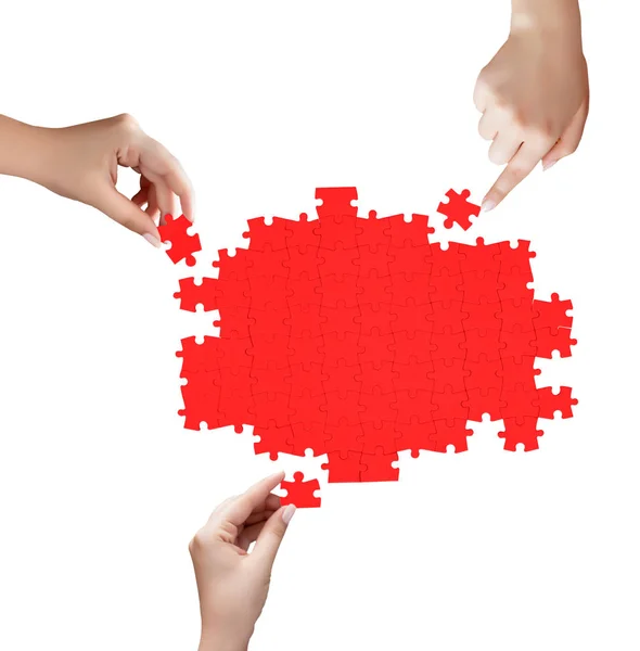 Hand holding a piece of red uncompleted puzzle — Stock Photo, Image