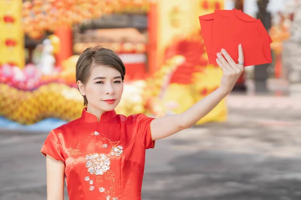 An Asian woman is wearing a red dress, Chinese New Year.