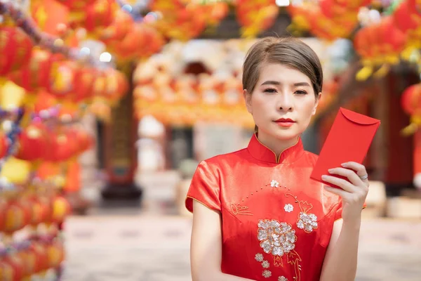 An Asian woman is wearing a red dress, Chinese New Year.