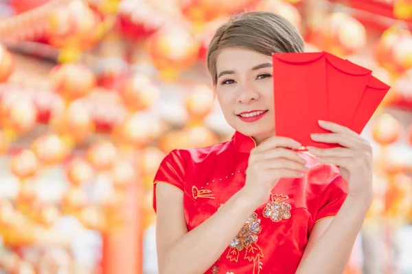 Asian women wearing red dresses, Chinese New Year.