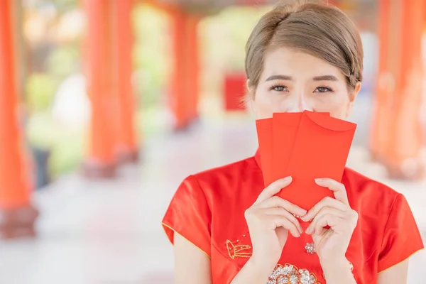 Asian women wearing red dresses, Chinese New Year.