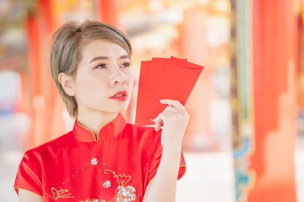 Asian women wearing red dresses, Chinese New Year.