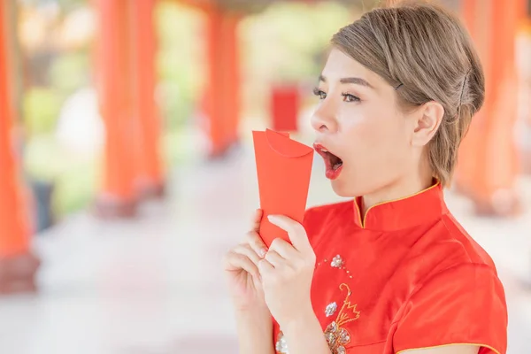 Asian women wearing red dresses, Chinese New Year.