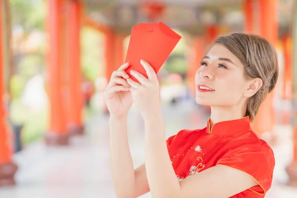 Asian women wearing red dresses, Chinese New Year.