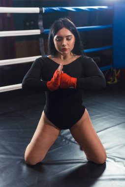 Boksör kadın elleri boks ringinde kırmızı boks örtüsüyle. Yakın plan çekim. Kadın Dövüşçünün Yakın Çekim Elleri Boks Sargıları Hazırlık. Kadın gücü ve erkeklik kavramı. El çırp.