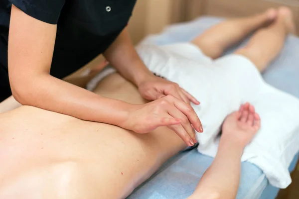 Young guy doing back massage. Health Care, Relaxation. — Stock Photo, Image