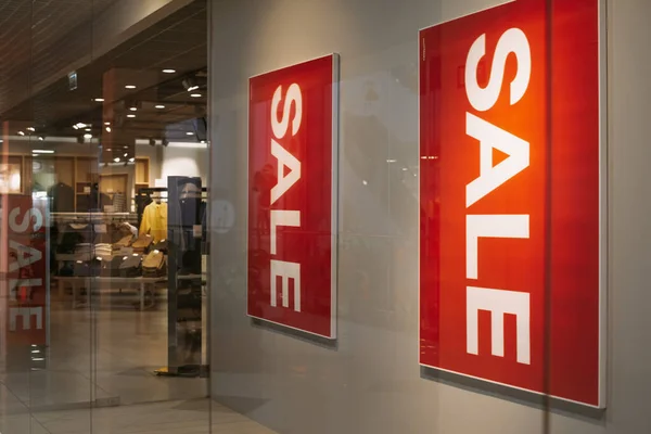 Sale at a clothing store. Red posters with the word Sale at the entrance to the mall — 스톡 사진