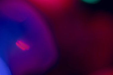 abstract lens flare on black background. blue, red, purple, pink defocused bokeh lights. glowing color burst. bokeh abstract backdrop