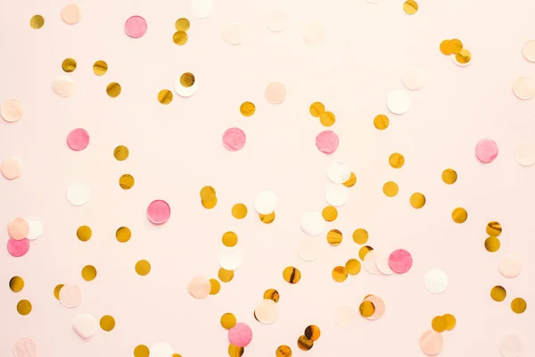 pink and gold round confetti on a pink pastel background. Template for advertising, blog, discounts and text.