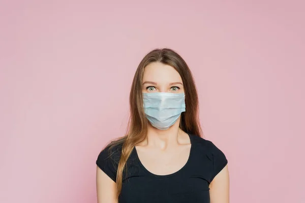 Flu epidemic, dust allergy, virus. Corona virus pandemic. Studio portrait of young woman wearing a face mask.