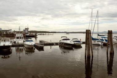 Boats and yachts moored on a marina of Lake Champlain waterfront on a Fall day in Burlington.  Vermont, USA clipart